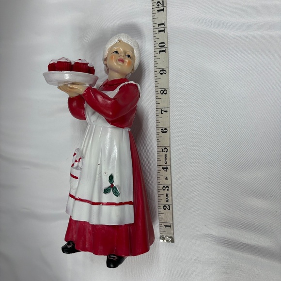 Mrs Claus figurine holding a tray of red cupcakes. - Picture 5 of 7